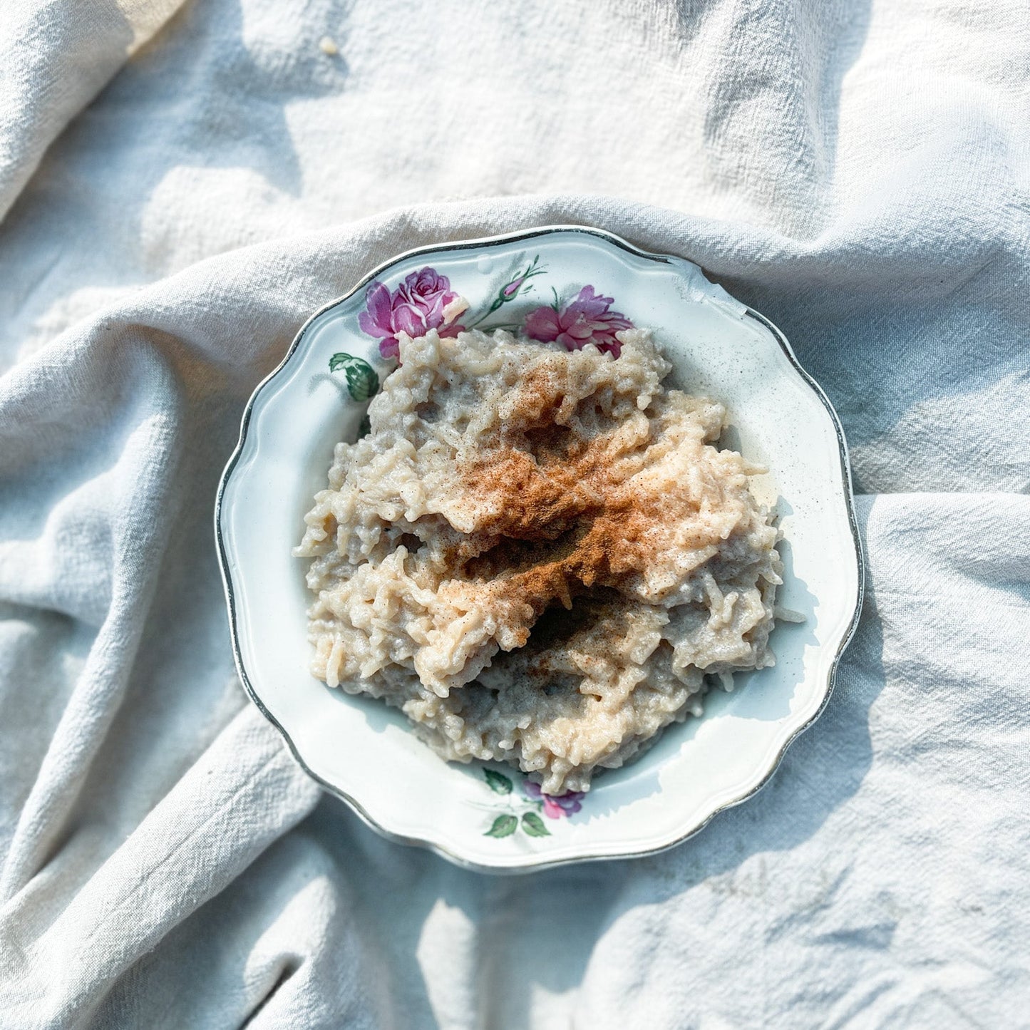 Plate of rice pudding on a textured white cloth